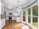 Well-lit kitchen featuring white cabinets, stainless steel appliances, and a large window overlooking the backyard at 1120 Millwright Ln, Matthews, NC 28104