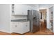 Kitchenette area with stainless refrigerator, white cabinets, and granite countertops at 1120 Millwright Ln, Matthews, NC 28104