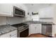Kitchen featuring stainless steel appliances, white cabinets, and granite countertops at 1120 Millwright Ln, Matthews, NC 28104