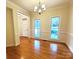 Well-lit living room with hardwood floors, a chandelier, and large windows for natural light at 1120 Millwright Ln, Matthews, NC 28104