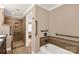 Bright bathroom featuring a walk-in shower with a separate soaking tub and grab bars at 1139 Suttle Rd, Lancaster, SC 29720