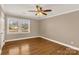 Bright bedroom with hardwood floors, ceiling fan, and natural light from a large window at 1139 Suttle Rd, Lancaster, SC 29720