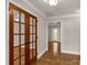 Inviting hallway with hardwood floors, crown molding, and elegant french doors at 1139 Suttle Rd, Lancaster, SC 29720