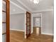 Well-lit hallway featuring hardwood floors, decorative doors, and neutral paint at 1139 Suttle Rd, Lancaster, SC 29720