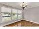 Bright living room featuring hardwood floors, large windows, and an elegant chandelier at 1139 Suttle Rd, Lancaster, SC 29720