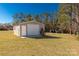 Metal storage shed featuring a roll up door is in a grassy yard at 1139 Suttle Rd, Lancaster, SC 29720