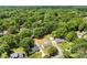 Aerial view of a neighborhood, showing homes surrounded by mature trees at 1316 Fox Run Dr, Charlotte, NC 28212