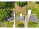 An aerial view of three homes with green lawns in a tree-lined neighborhood at 1316 Fox Run Dr, Charlotte, NC 28212