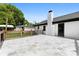 Spacious backyard patio with tile flooring, leading to a backyard with mature trees at 1316 Fox Run Dr, Charlotte, NC 28212