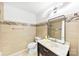 Bathroom with a marble vanity, modern lighting, and tiled walls and shower at 1316 Fox Run Dr, Charlotte, NC 28212