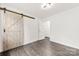 Spacious bedroom with ample natural light and barn door at 1316 Fox Run Dr, Charlotte, NC 28212