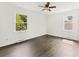 Light and bright bedroom with hardwood floors and two windows overlooking the outdoors at 1316 Fox Run Dr, Charlotte, NC 28212