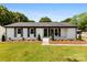 Charming single-story home featuring a well-maintained lawn and a classic white brick facade with black shutters at 1316 Fox Run Dr, Charlotte, NC 28212