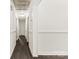 Long hallway with white walls, dark hardwood floors, and neutral wall trim at 1316 Fox Run Dr, Charlotte, NC 28212