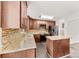 Well-appointed kitchen featuring stone countertops, stainless steel appliances, and dark wood cabinets at 1316 Fox Run Dr, Charlotte, NC 28212