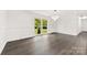 Bright living room featuring refinished hardwood floors, modern lighting, and a view of the landscaped front yard at 1316 Fox Run Dr, Charlotte, NC 28212