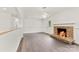 Open living space featuring a stone fireplace, dark wood floors, and seamless design to the adjacent rooms at 1316 Fox Run Dr, Charlotte, NC 28212