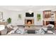 Comfortable living room with a stone fireplace, stylish furniture, and a view of the backyard through the window at 1316 Fox Run Dr, Charlotte, NC 28212