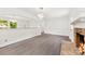 Bright living room with stone fireplace and hardwood floors, great for entertaining guests at 1316 Fox Run Dr, Charlotte, NC 28212