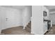 A home entryway featuring vinyl flooring, a carpeted staircase, white walls, and access to the kitchen area at 1439 Mammoth Rd, Hickory, NC 28602