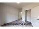 Bedroom with carpeted floors, closet, and a doorway to an adjoining room at 1501 School Ave, Gastonia, NC 28052