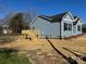 Charming blue house featuring a wooden deck and manicured lawn at 1501 School Ave, Gastonia, NC 28052