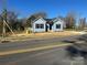 Charming blue home with black shutters and a manicured lawn at 1501 School Ave, Gastonia, NC 28052