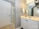 A bright bathroom features a walk-in shower, a mirrored vanity, and a separate toilet room at 151 E Morehouse Ave, Mooresville, NC 28117