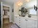 A tiled bathroom with double sinks and white cabinets is conveniently located next to the main bedroom at 151 E Morehouse Ave, Mooresville, NC 28117