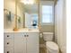 Bathroom featuring white cabinetry, a large mirror, and plenty of natural light at 151 E Morehouse Ave, Mooresville, NC 28117