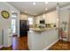 Well-lit kitchen with stainless steel appliances, granite countertops, and hardwood floors at 151 E Morehouse Ave, Mooresville, NC 28117