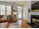 Cozy living room with a fireplace, hardwood floors, and a view of the front door at 151 E Morehouse Ave, Mooresville, NC 28117