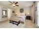 A cozy bedroom boasts a ceiling fan, a decorative wall basket, and access to a private bathroom at 151 E Morehouse Ave, Mooresville, NC 28117