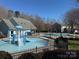 Community pool area featuring a splash pad and a larger swimming pool, perfect for Gathering fun and relaxation at 151 E Morehouse Ave, Mooresville, NC 28117