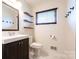 Modern bathroom with marble floors, floating shelves, and a stylish vanity at 1621 Keeling Pl, Charlotte, NC 28210