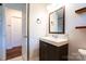 Modern bathroom with floating vanity, stylish fixtures, and doorway to another room at 1621 Keeling Pl, Charlotte, NC 28210