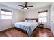 Bedroom with ceiling fan, windows, wood floors, and a decorative rug at 1621 Keeling Pl, Charlotte, NC 28210