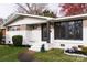 Charming home featuring a brick and white facade with a well-manicured lawn and mature trees at 1621 Keeling Pl, Charlotte, NC 28210