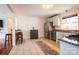 Well-lit kitchen with stainless steel appliances, stone countertops and an eat-in bar area at 1621 Keeling Pl, Charlotte, NC 28210