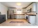 Well-lit kitchen featuring stainless steel appliances, granite countertops, and ample cabinet space at 1621 Keeling Pl, Charlotte, NC 28210