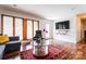 Inviting living room with hardwood floors, a stylish sofa, and natural light from large windows at 1621 Keeling Pl, Charlotte, NC 28210