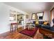 Inviting living room with hardwood floors, a stylish sofa, and a view into the updated kitchen at 1621 Keeling Pl, Charlotte, NC 28210