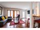 Inviting living room with hardwood floors, a stylish sofa, and natural light from large windows at 1621 Keeling Pl, Charlotte, NC 28210