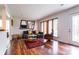 Inviting living room with hardwood floors, a stylish sofa, and natural light from large windows at 1621 Keeling Pl, Charlotte, NC 28210