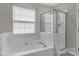 Bright bathroom featuring a large soaking tub, and glass shower at 187 Snead Rd, Fort Mill, SC 29715