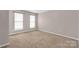 Bright bedroom featuring two windows, carpet and light-colored walls at 187 Snead Rd, Fort Mill, SC 29715