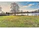 Backyard with a large lake view and a grassy yard at 2013 Barkley Cir, Monroe, NC 28112