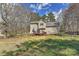 Backyard featuring a deck, level grassy area, chain link fence, and mature trees at 2013 Barkley Cir, Monroe, NC 28112