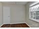 Bedroom featuring hardwood floors, neutral walls, and a window providing natural light at 2013 Barkley Cir, Monroe, NC 28112