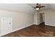 View of a bedroom with dark-stained wood floors, a ceiling fan and a closet door at 2013 Barkley Cir, Monroe, NC 28112